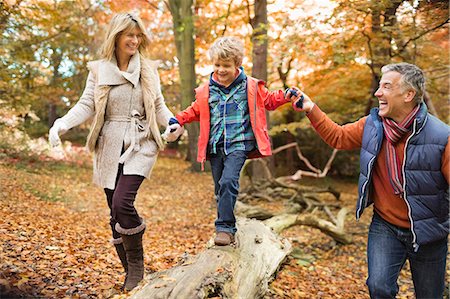 extended family walking outdoors - Family walking on log in park Stock Photo - Premium Royalty-Free, Code: 6113-06721260