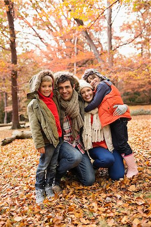 smiling boy girl hugging outdoors - Family smiling together in park Stock Photo - Premium Royalty-Free, Code: 6113-06721264