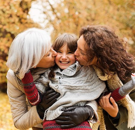 fall day family park - Woman and daughter kissing girl in park Stock Photo - Premium Royalty-Free, Code: 6113-06721214