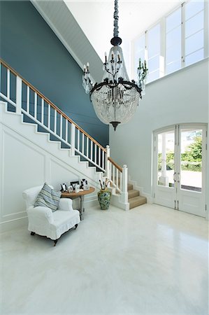 simsearch:6113-06753892,k - Chandelier hanging over elegant foyer Stock Photo - Premium Royalty-Free, Code: 6113-06898671