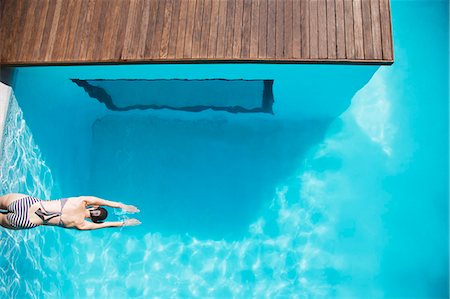 swimming pool - Woman in luxury swimming pool Stock Photo - Premium Royalty-Free, Code: 6113-06898819
