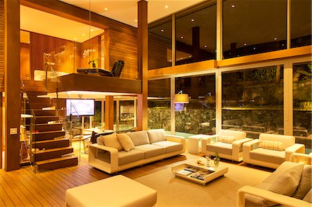 Illuminated modern living room at night Stock Photo - Premium Royalty-Free, Code: 6113-06898831