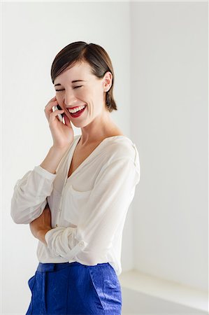 simsearch:6113-06898942,k - Laughing woman talking on cell phone Stock Photo - Premium Royalty-Free, Code: 6113-06898947