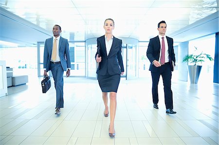 Determined business people walking in lobby Stock Photo - Premium Royalty-Free, Code: 6113-06898990