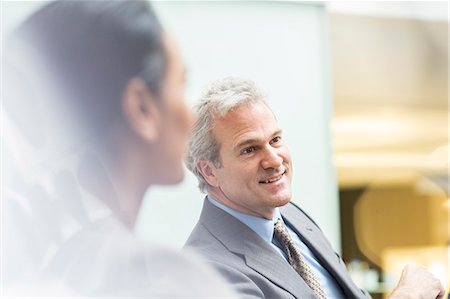 Smiling businessman in meeting Stock Photo - Premium Royalty-Free, Code: 6113-06899045