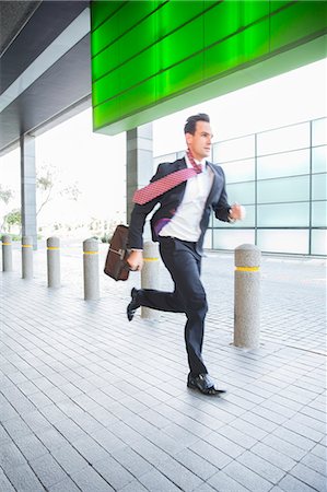 Businessman running Stock Photo - Premium Royalty-Free, Code: 6113-06899098