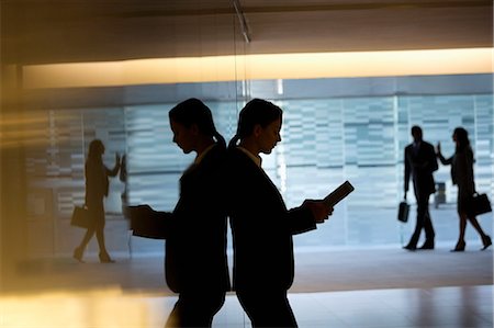 Businesswoman using digital tablet in lobby Stock Photo - Premium Royalty-Free, Code: 6113-06899004