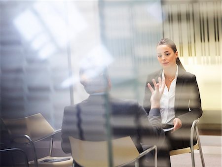 reflections windows - Businessman and businesswoman talking in office Stock Photo - Premium Royalty-Free, Code: 6113-06899034