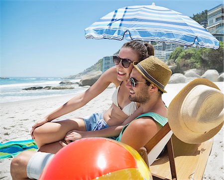 simsearch:6113-06899268,k - Happy couple relaxing on beach Stock Photo - Premium Royalty-Free, Code: 6113-06899186