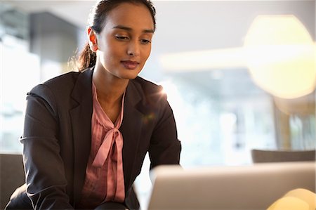 Businesswoman using laptop Stock Photo - Premium Royalty-Free, Code: 6113-06899100