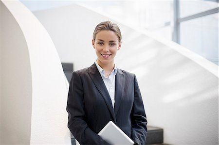 stairs closeup - Portrait of smiling businesswoman holding digital tablet Stock Photo - Premium Royalty-Free, Code: 6113-06899102