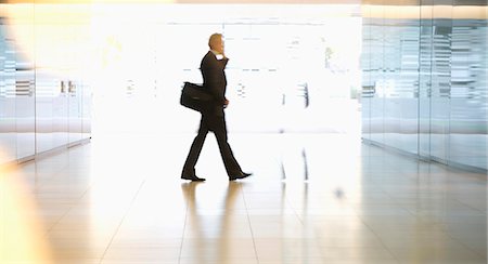 simsearch:6113-06898942,k - Businessman walking in lobby Stock Photo - Premium Royalty-Free, Code: 6113-06899114