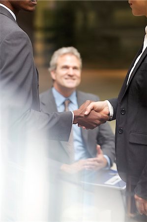 smile at work - Business people handshaking Stock Photo - Premium Royalty-Free, Code: 6113-06899135