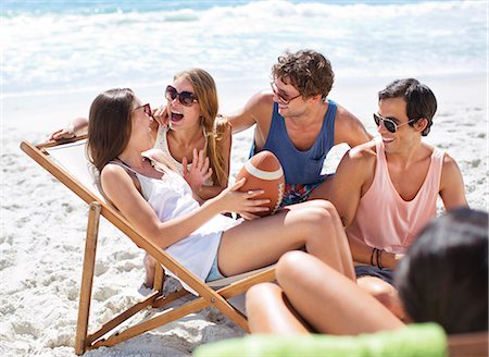 summer laughter sunglasses - Happy friends with football hanging out at beach Stock Photo - Premium Royalty-Free, Code: 6113-06899240