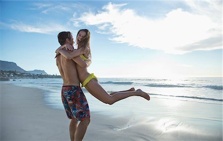 simsearch:6113-06899182,k - Happy couple hugging and spinning on beach Stock Photo - Premium Royalty-Free, Code: 6113-06899273