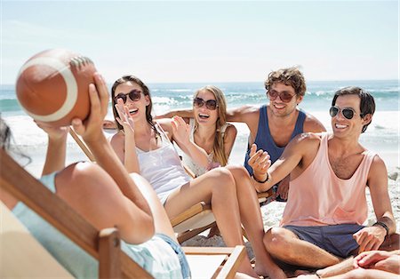 friends enjoying pictures - Happy friends with football hanging out at beach Stock Photo - Premium Royalty-Free, Code: 6113-06899288