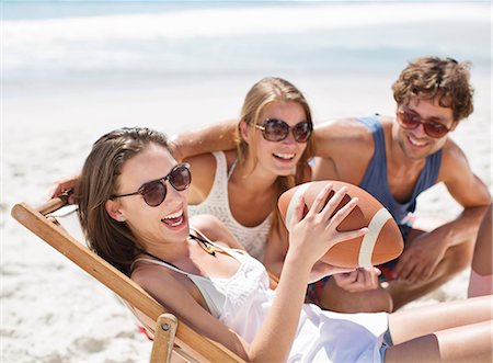 friendship travel adult - Smiling friends with football on beach Stock Photo - Premium Royalty-Free, Code: 6113-06899203