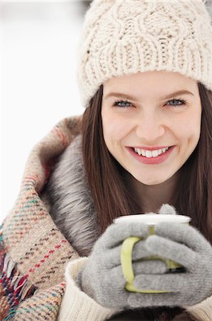 Close up portrait of woman in knit hat and gloves drinking coffee Stock Photo - Premium Royalty-Free, Code: 6113-06899345