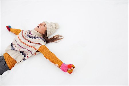 Enthusiastic woman making snow angel Foto de stock - Sin royalties Premium, Código: 6113-06899396