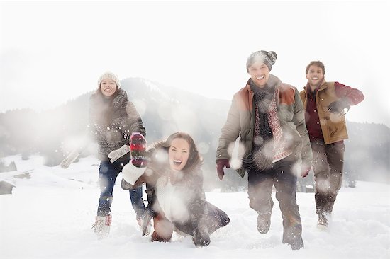 Portrait of friends playing in snowy field Photographie de stock - Premium Libres de Droits, Le code de l’image : 6113-06899306