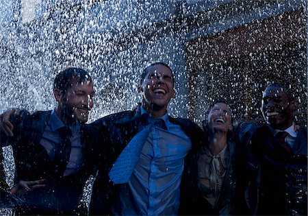 simsearch:6113-06899541,k - Enthusiastic businessmen in rain Photographie de stock - Premium Libres de Droits, Code: 6113-06899649