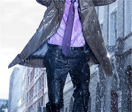 rain wet - Businessman running in rain Stock Photo - Premium Royalty-Free, Code: 6113-06899601