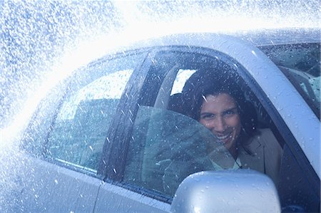 single car front - Portrait of smiling businesswoman inside car in rain Stock Photo - Premium Royalty-Free, Code: 6113-06899626