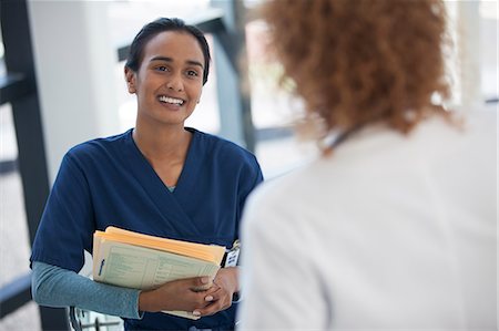scrubs - Nurse and doctor talking in hospital Stock Photo - Premium Royalty-Free, Code: 6113-06908193