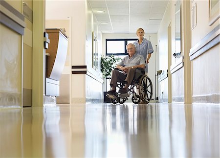 patient happy hospital - Nurse wheeling older patient in hospital Stock Photo - Premium Royalty-Free, Code: 6113-06908192