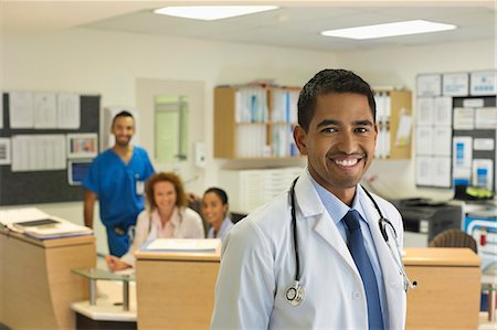 Doctor smiling in hospital hallway Stock Photo - Premium Royalty-Free, Code: 6113-06908244