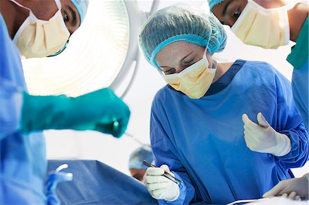 female latex gloves - Surgeons working in operating room Stock Photo - Premium Royalty-Free, Code: 6113-06908269