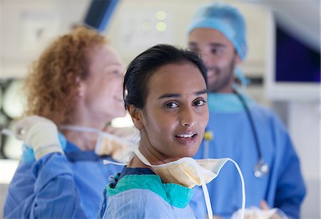 rubber gloves lady surgeon - Surgeons standing operating room Stock Photo - Premium Royalty-Free, Code: 6113-06908282