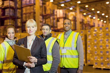 Workers and businesswoman in warehouse Stock Photo - Premium Royalty-Free, Code: 6113-06908352