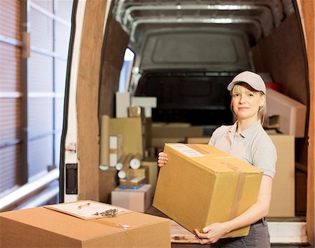 deliveryman woman - Delivery girl unloading boxes from van Stock Photo - Premium Royalty-Free, Code: 6113-06908354