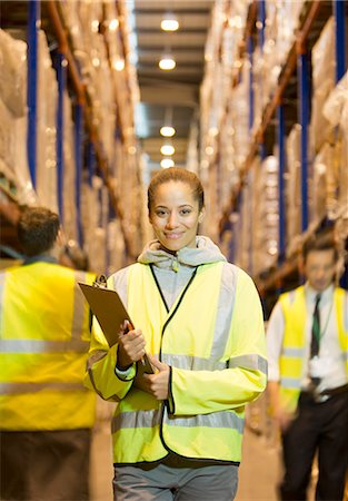 diverse coworkers - Worker holding clipboard in warehouse Stock Photo - Premium Royalty-Free, Code: 6113-06908367