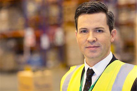 simsearch:6113-06908404,k - Businessman standing in warehouse Stock Photo - Premium Royalty-Free, Code: 6113-06908375