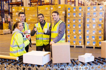 Workers drinking coffee in warehouse Stock Photo - Premium Royalty-Free, Code: 6113-06908392