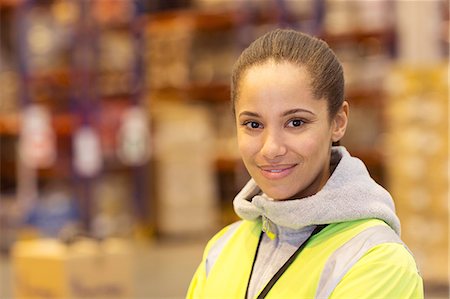 female worker - Worker smiling in warehouse Stock Photo - Premium Royalty-Free, Code: 6113-06908399