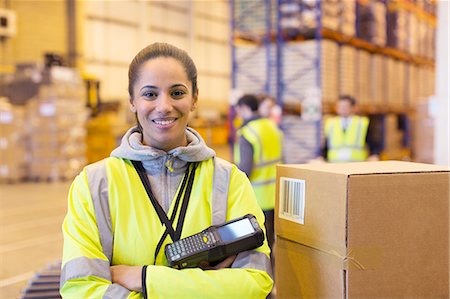 portrait worker woman - Worker holding scanner in warehouse Stock Photo - Premium Royalty-Free, Code: 6113-06908453