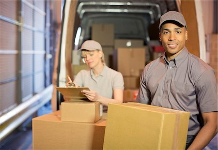 Delivery people loading boxes into van Stock Photo - Premium Royalty-Free, Code: 6113-06908457