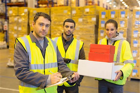 simsearch:6113-06908412,k - Workers standing in warehouse Photographie de stock - Premium Libres de Droits, Code: 6113-06908470