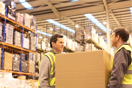 storage (industrial and commercial) - Workers carrying box in warehouse Stock Photo - Premium Royalty-Free, Code: 6113-06908477