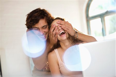 simsearch:6113-06908528,k - Man covering girlfriend's eyes indoors Stock Photo - Premium Royalty-Free, Code: 6113-06908495