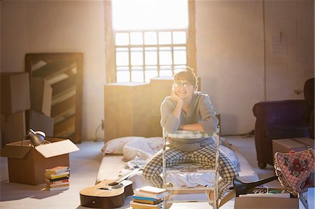 portrait of student - Woman unpacking boxes in attic Stock Photo - Premium Royalty-Free, Code: 6113-06908567