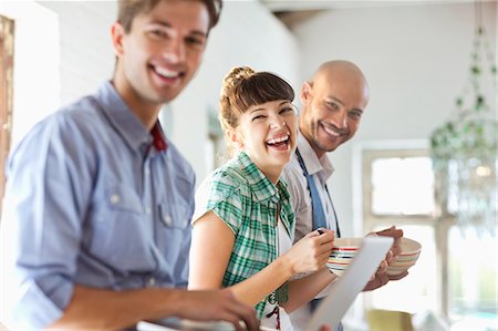 eating laughing - Friends having breakfast together in kitchen Stock Photo - Premium Royalty-Free, Code: 6113-06908568