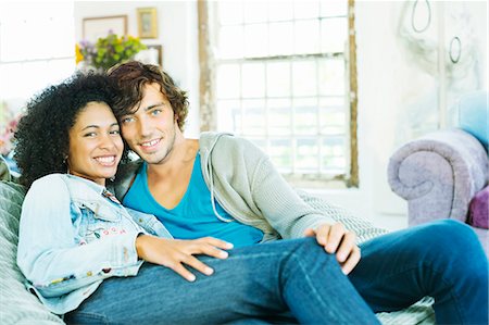simsearch:6113-06908557,k - Couple relaxing together on sofa Stock Photo - Premium Royalty-Free, Code: 6113-06908575