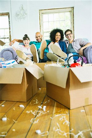 Friends relaxing in new home Stock Photo - Premium Royalty-Free, Code: 6113-06908510