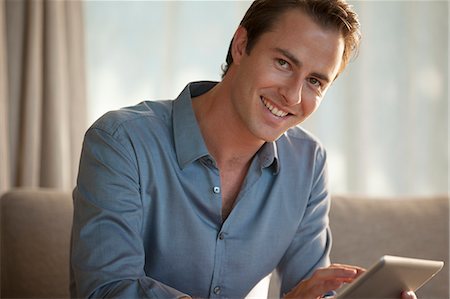 Businessman smiling on sofa Stock Photo - Premium Royalty-Free, Code: 6113-06908744