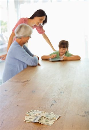 smiling senior people talking family - Three generations of women counting money Stock Photo - Premium Royalty-Free, Code: 6113-06908769