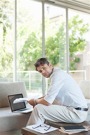 Businessman using laptop on sofa Stock Photo - Premium Royalty-Free, Code: 6113-06908729